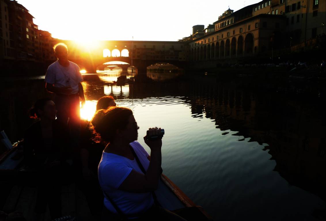 fall in love with florence living the magic of the sunset light and the golden reflections on the calm water of the Arno river