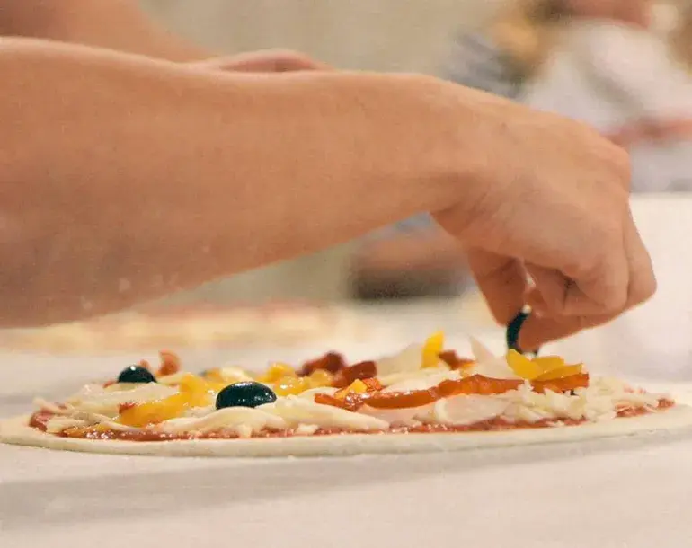 Garnish your own pizza during our pizza and gelato class near Florence